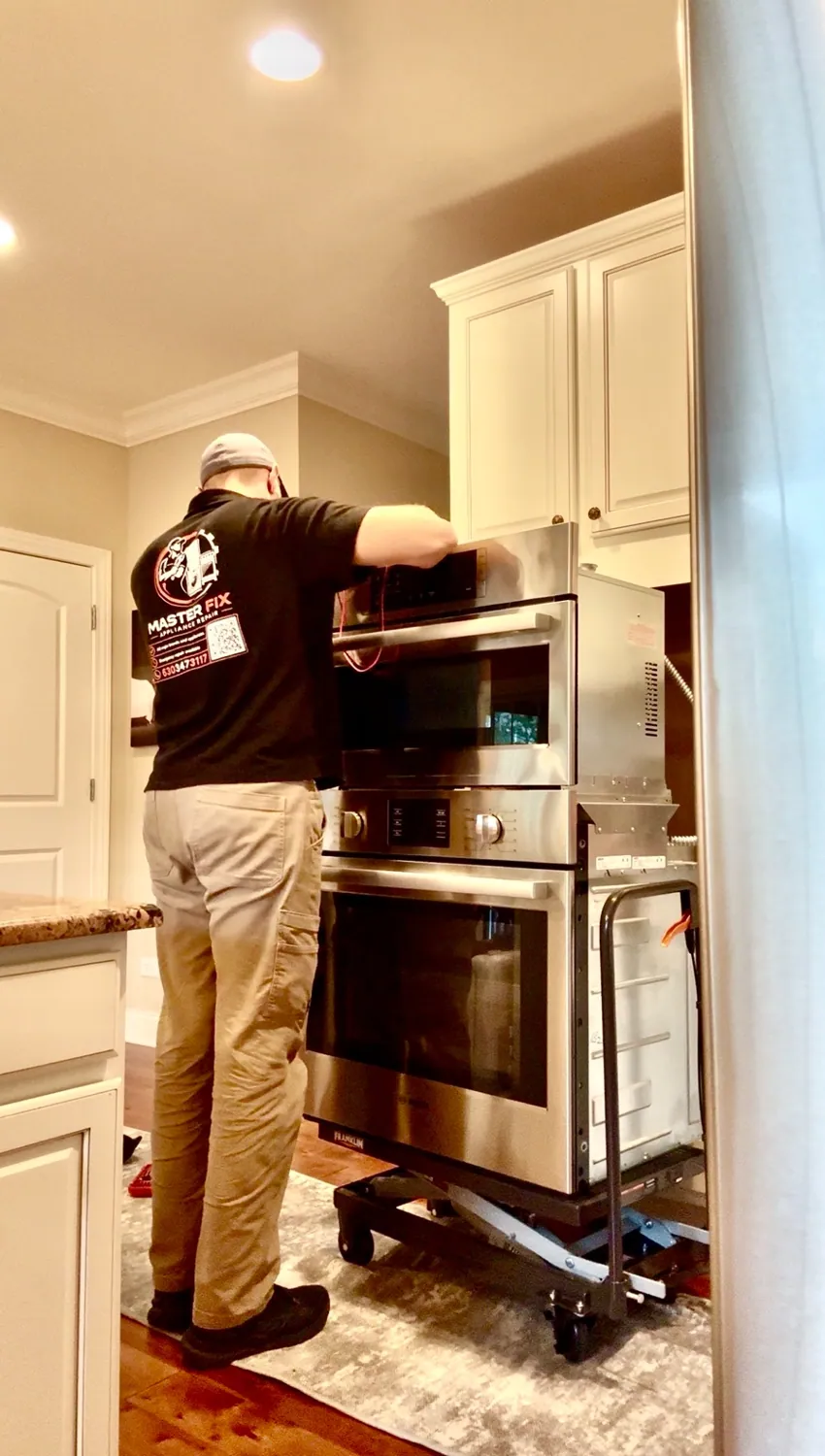 MasterFix technician working on an appliance