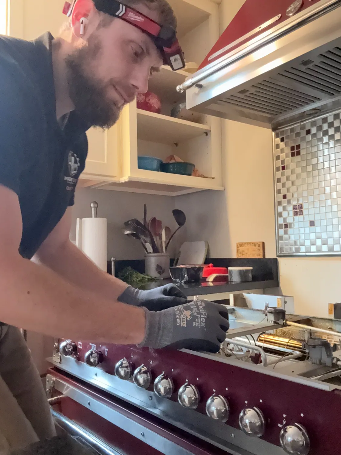 Technician working on a Bertazzoni gas range